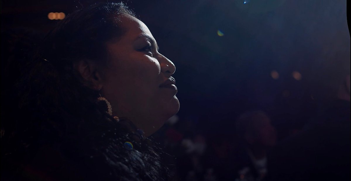 Profile of a woman looking to the right, lit dramatically with high contrast