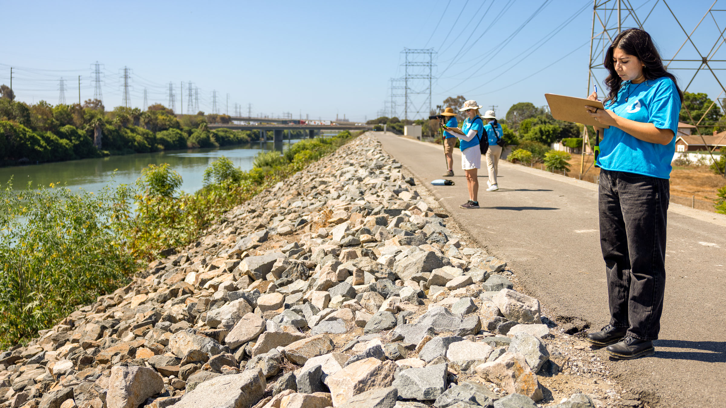 Jessica Medrano at rivers edge surveying turtles with other people