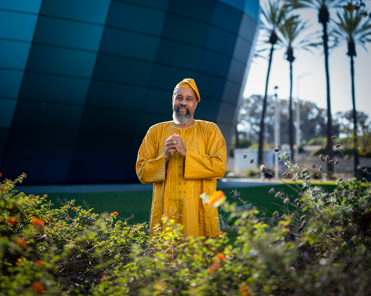 Yellow clothed man in front of Pacific Visions.