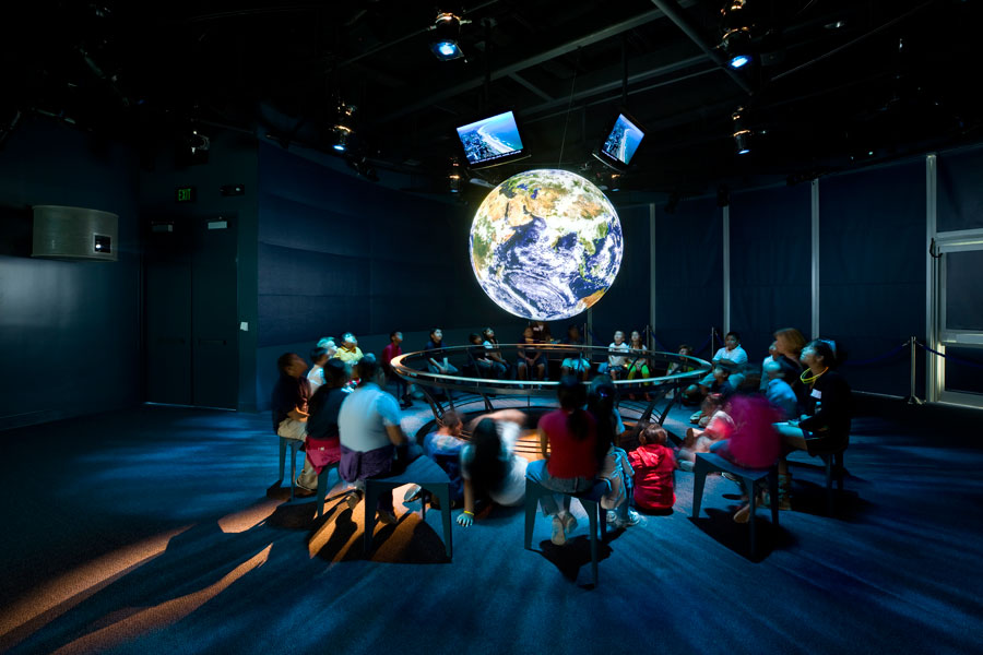 Ocean Science Center interior with people around globe