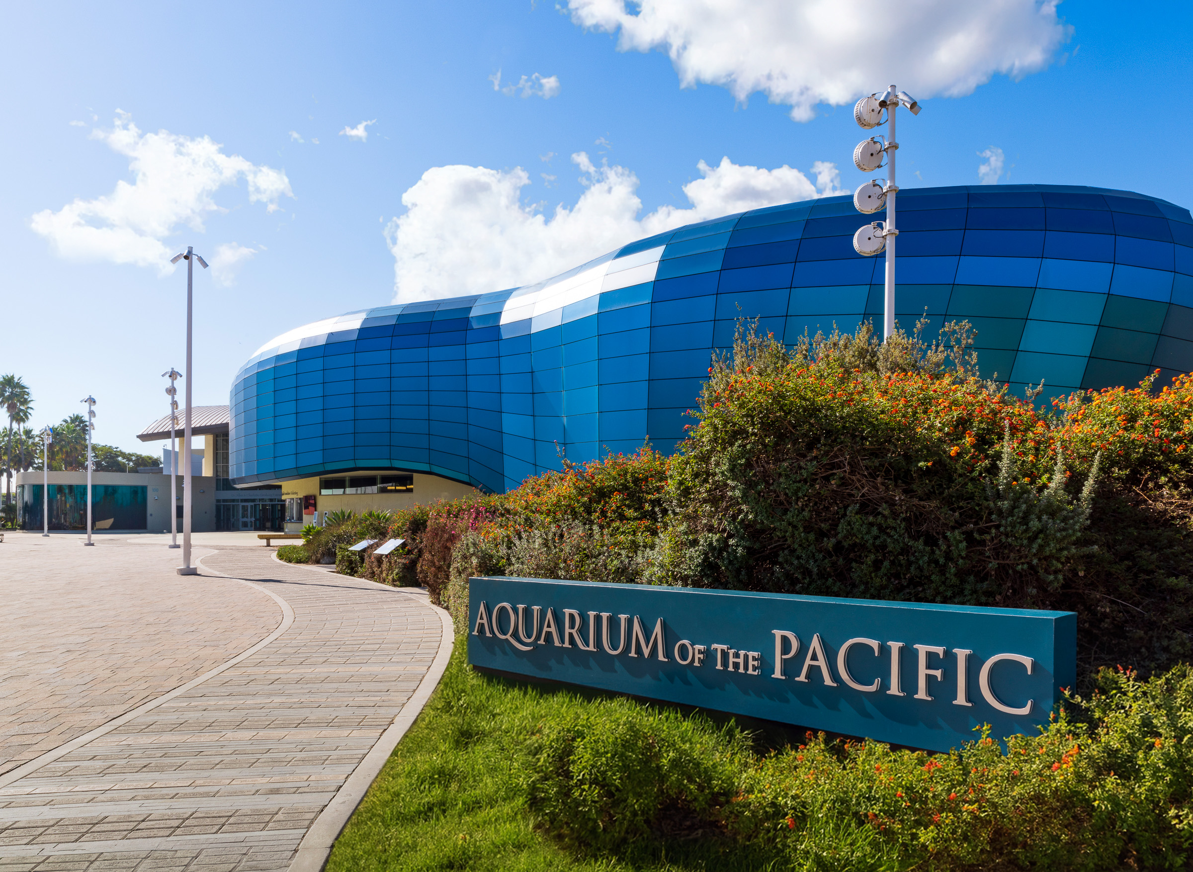 Aquarium title graphics with Pacific Visions building in background