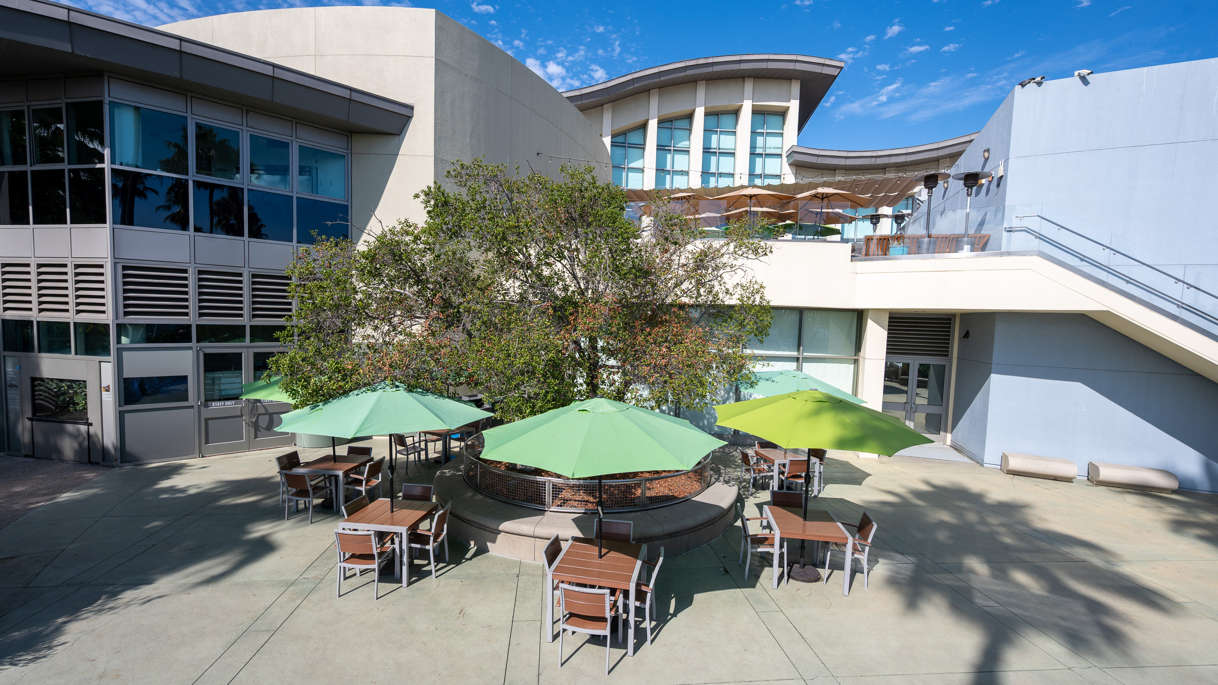 View of Harbor Terrace with Aquarium building and table and chairs