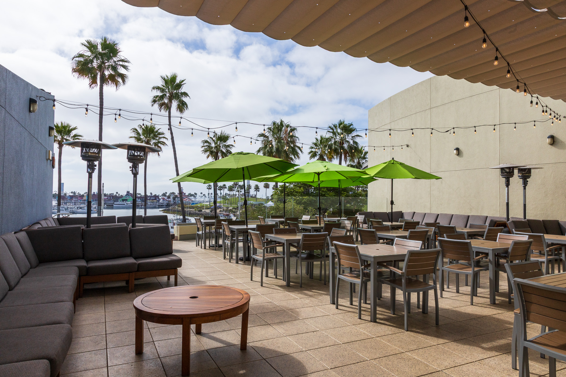 View of Veranda area with tables chairs couches and umbrellas